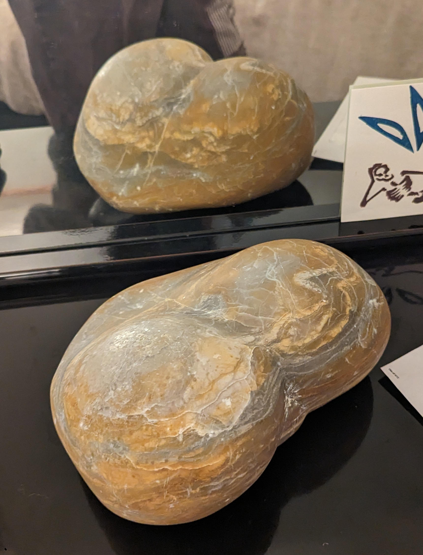 an abstract sculpture made from alabaster. it resembles a heart and a butt