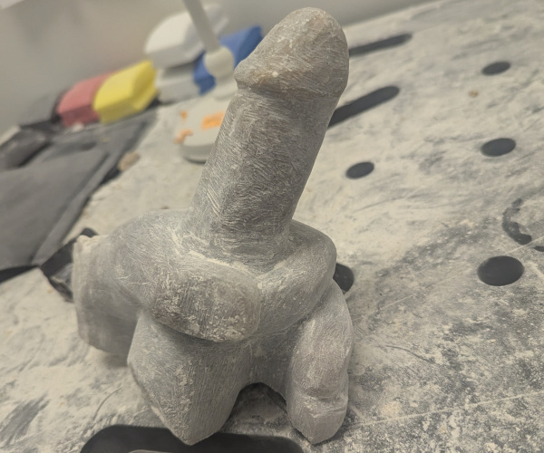 a sculpture made from alabaster featuring an erect penis