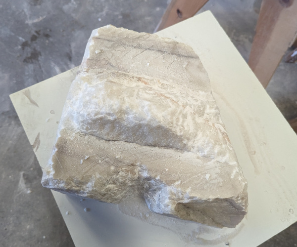 a sculpture made from marble showing a nude male figure