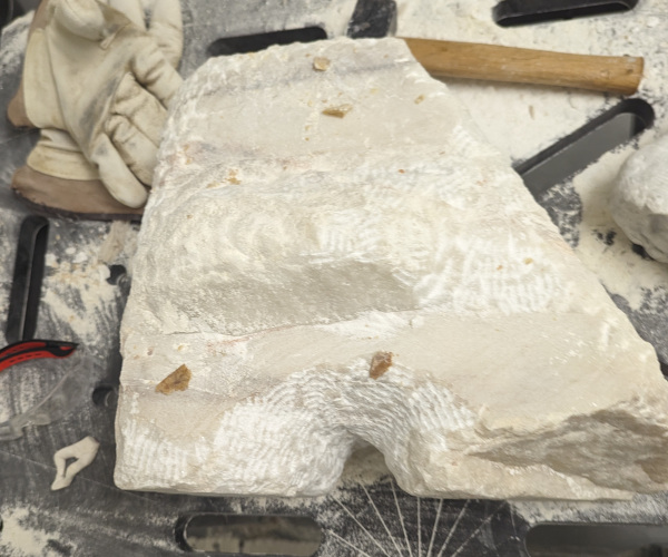 a sculpture made from marble showing a nude male figure