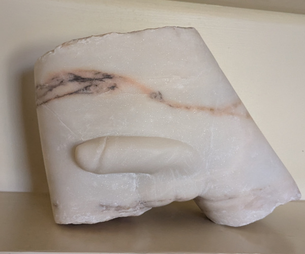 a sculpture made from marble showing a nude male figure